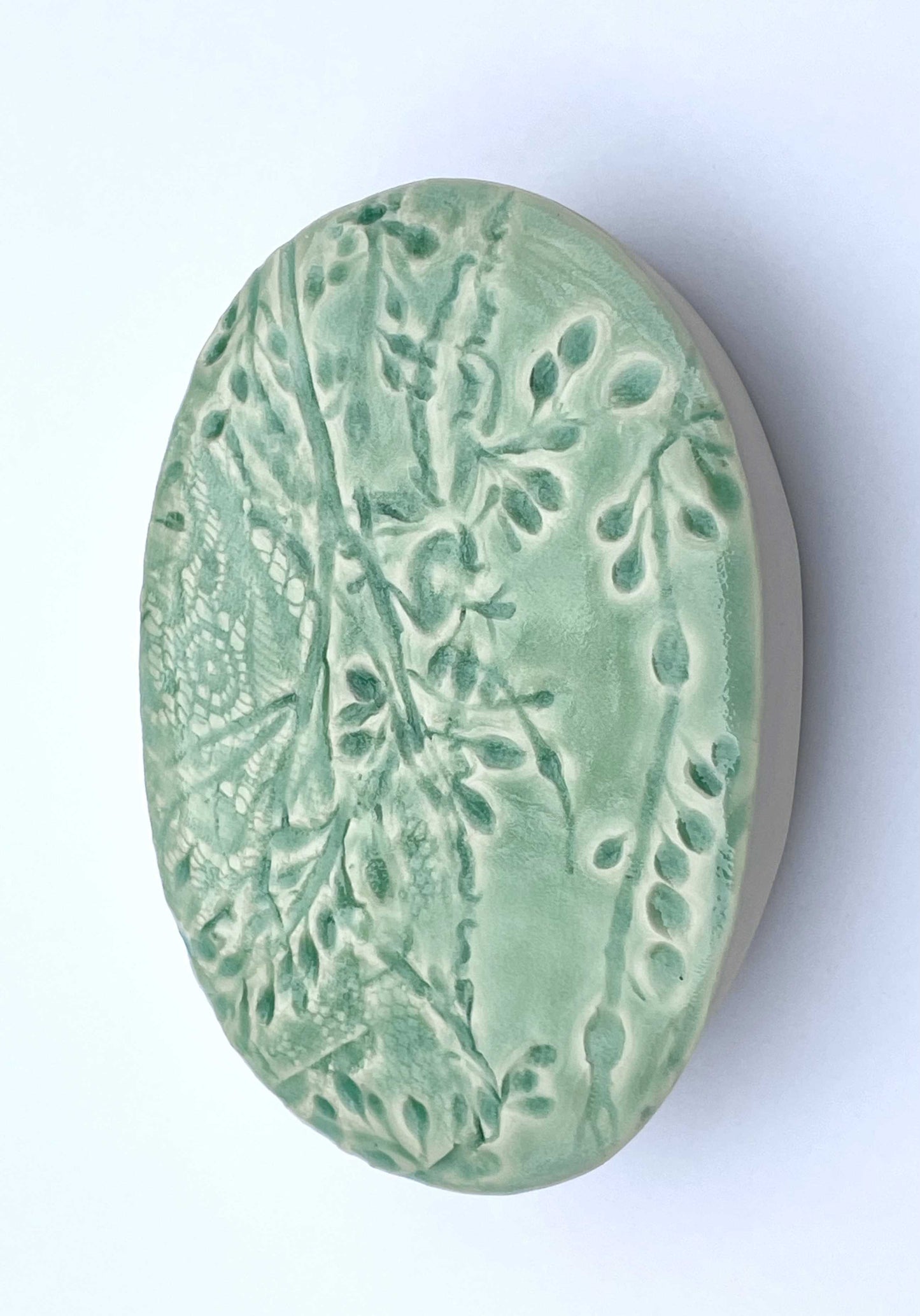 Green ceramic oval with seaweed pattern