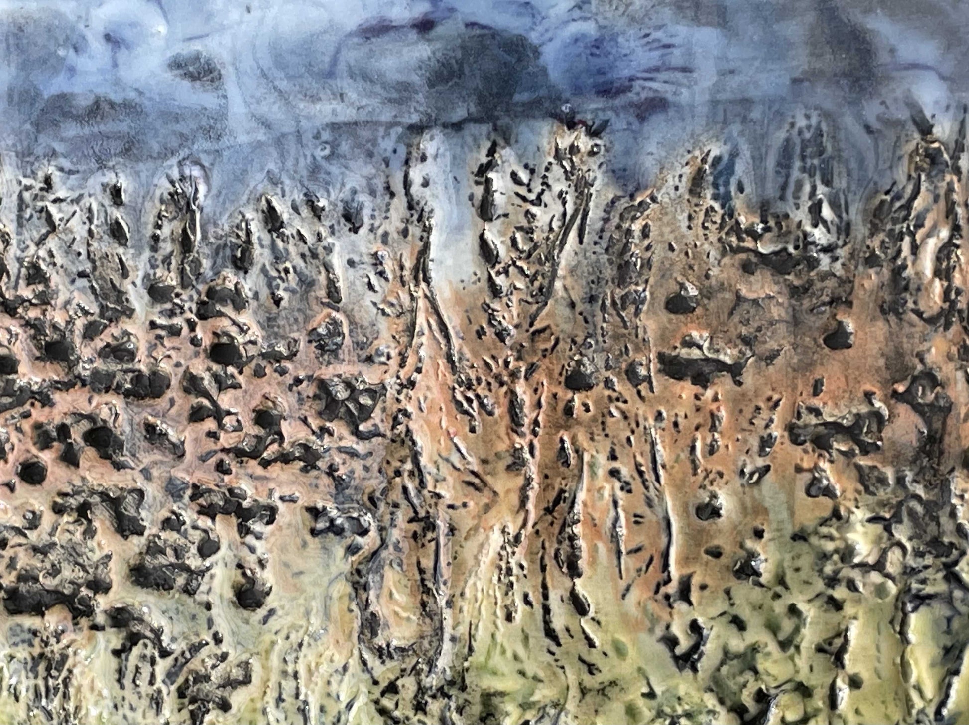 detail of surface texture of wall-hung porcelain sculptural tile representing an abstract river scene