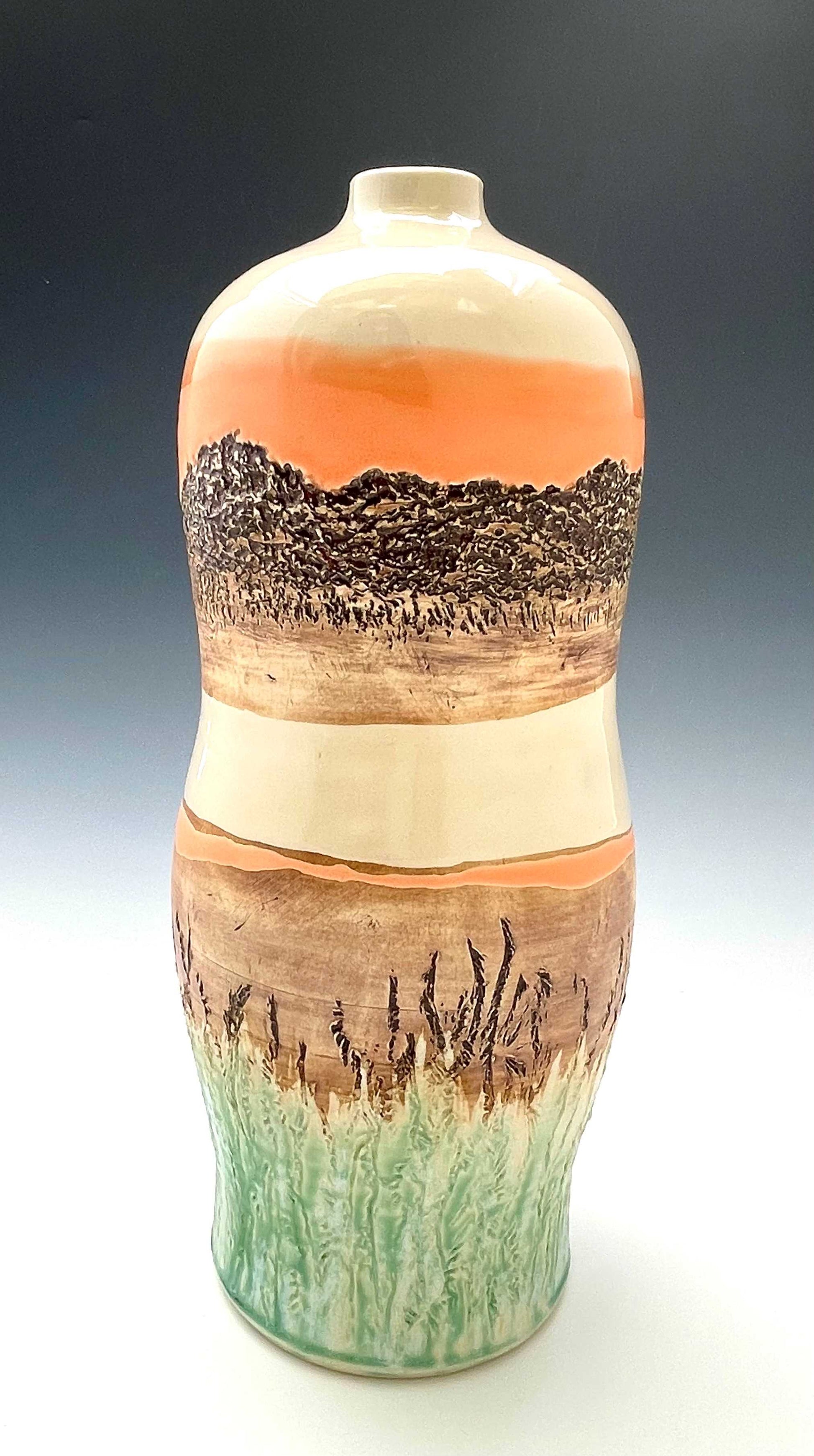 Tall wheel-thrown porcelain vase with coral, brown, white and light green glazes and a textured surface, representing a river sunset scene