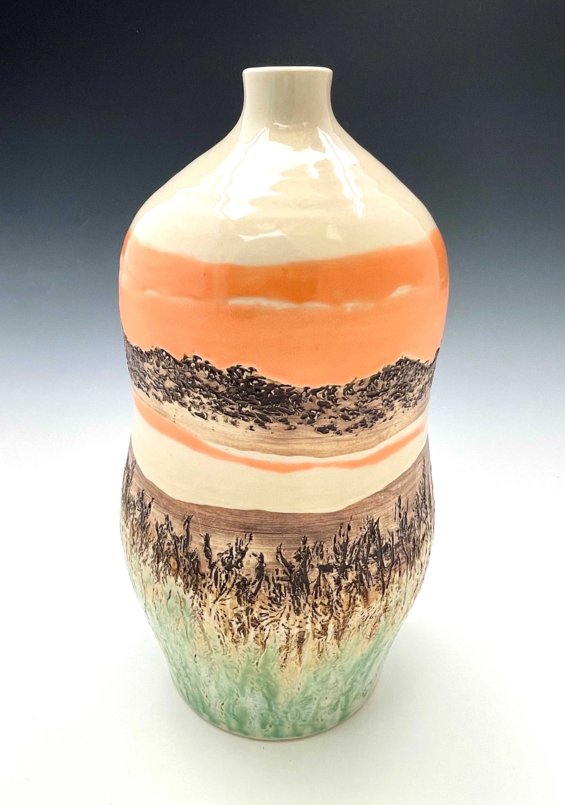 Tall wheel-thrown porcelain vase with coral, brown, white and light green glazes and a textured surface, representing a river sunset scene