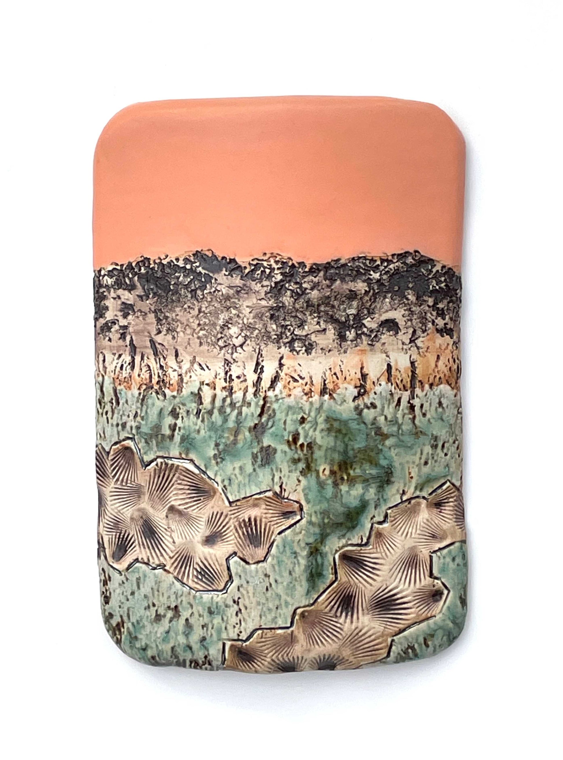 Rectangular porcelain wall-hung sculptural tile with coral, white, brown and green glazes on a textured surface, representing an abstract sunset landscape scene