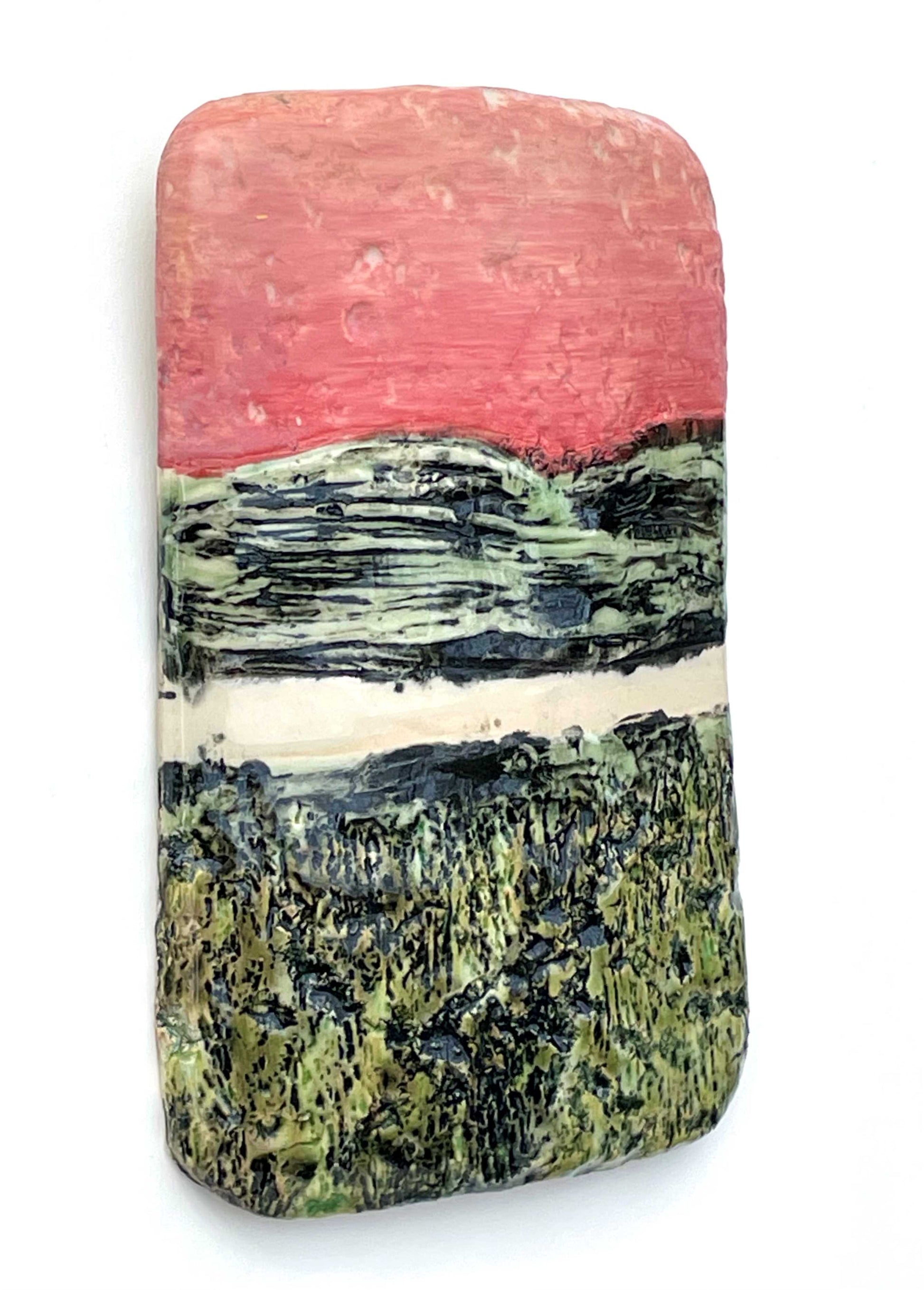 side view of a rectangular porcelain wall-hung sculptural tile with coral, white and black and green glazes on a textured surface, representing an abstract sunset river scene