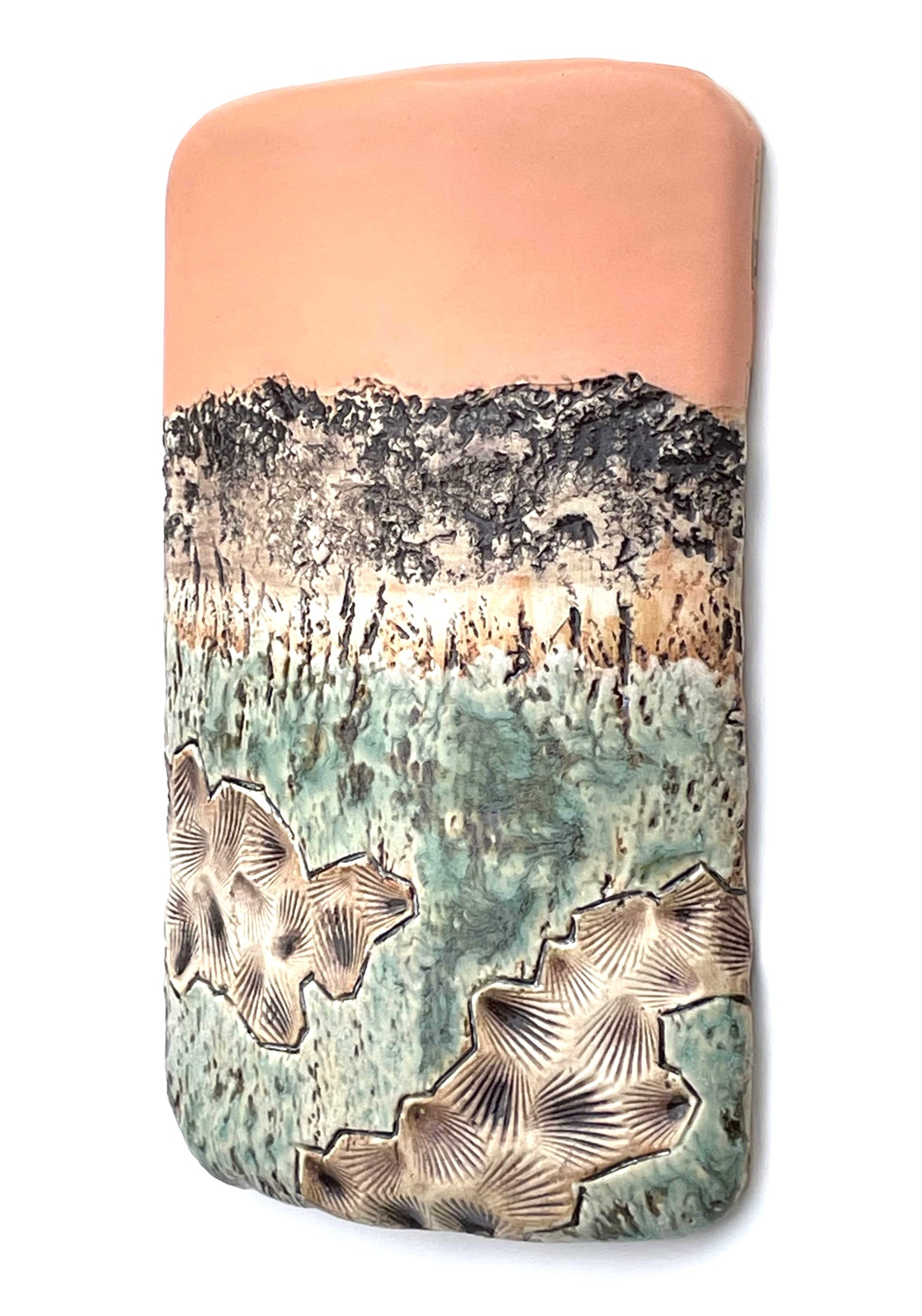 side view of a rectangular porcelain wall-hung sculptural tile with coral, white, brown and green glazes on a textured surface, representing an abstract sunset landscape scene