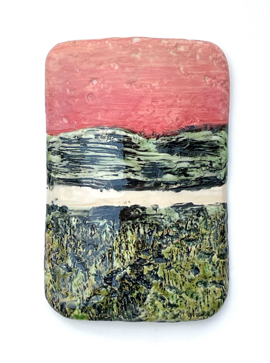 Rectangular porcelain wall-hung sculptural tile with coral, white and black and green glazes on a textured surface, representing an abstract sunset river scene