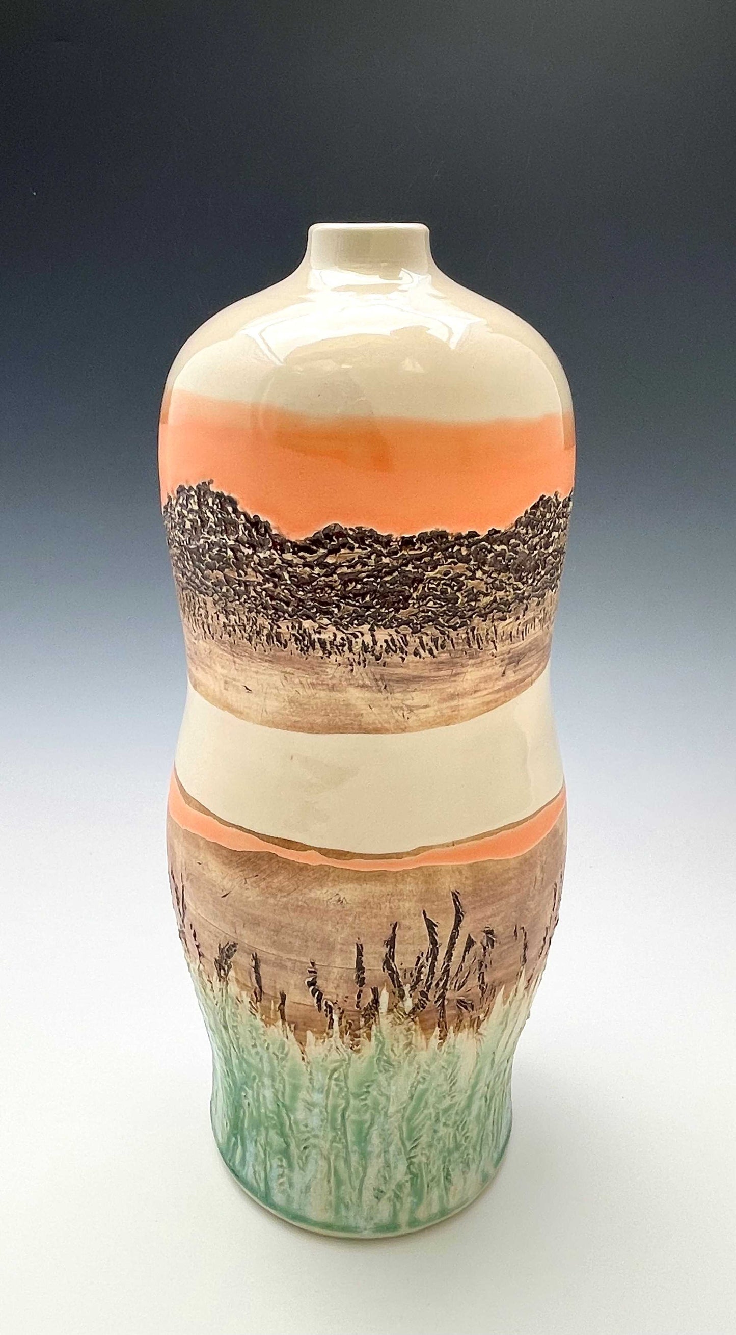 Tall wheel-thrown porcelain vase with coral, brown, white and light green glazes and a textured surface, representing a riverside sunset