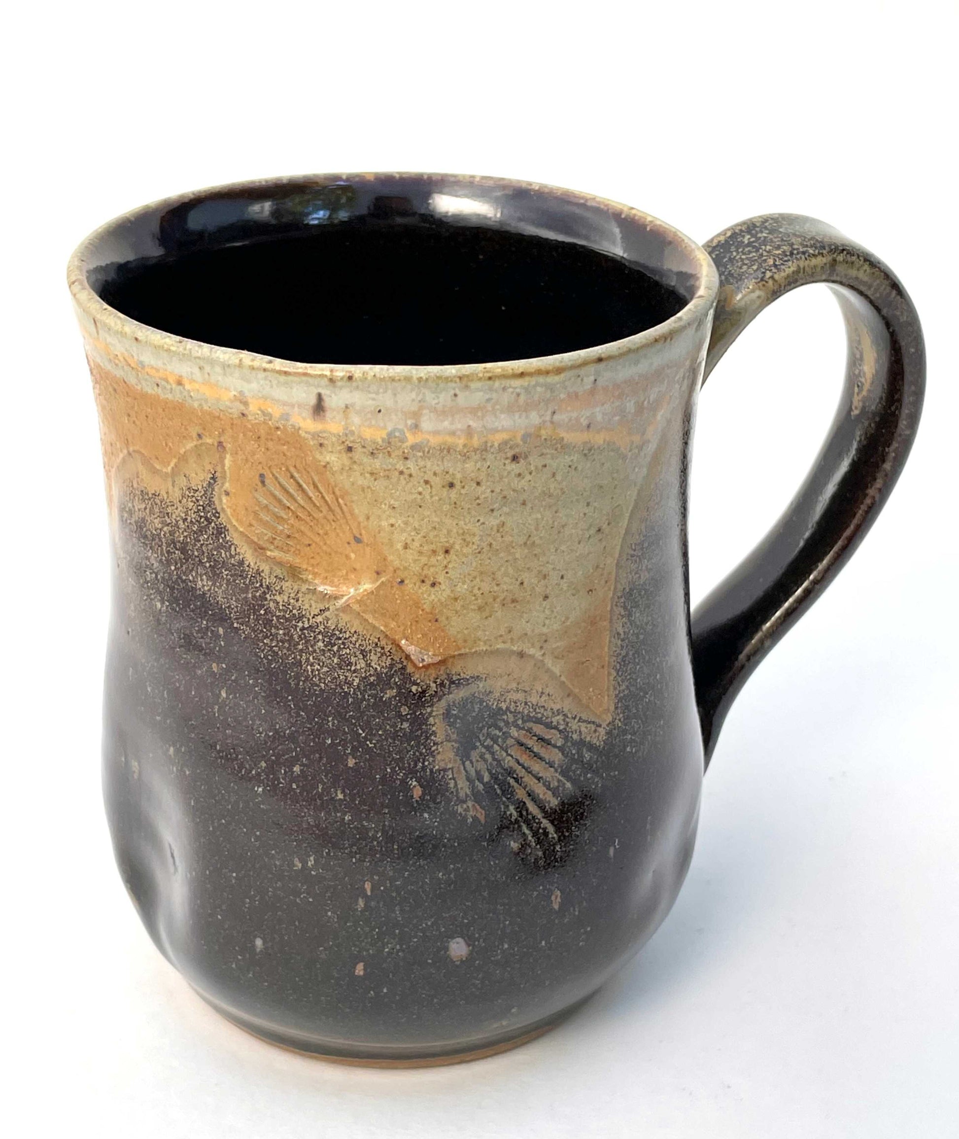 Ceramic mug with shell imprints and brown glazes