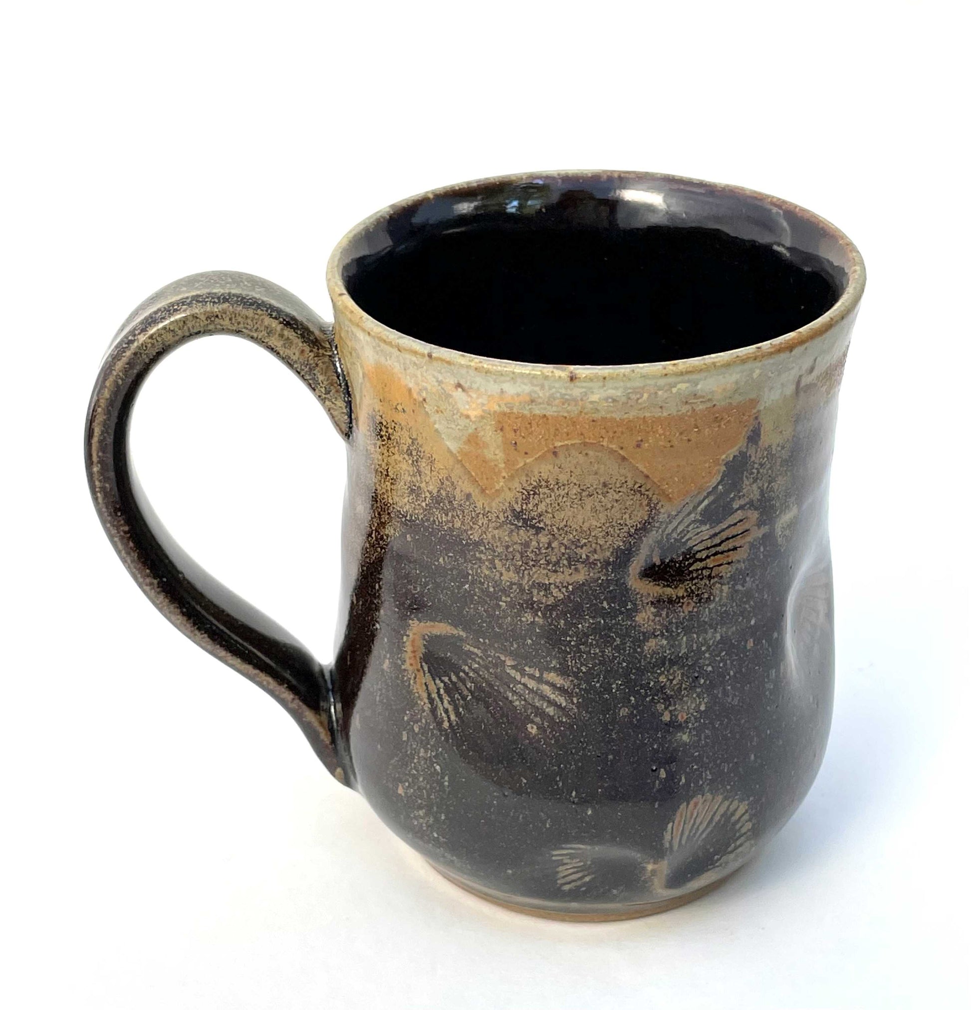 Ceramic mug with shell imprints and brown, orange and tan glazes