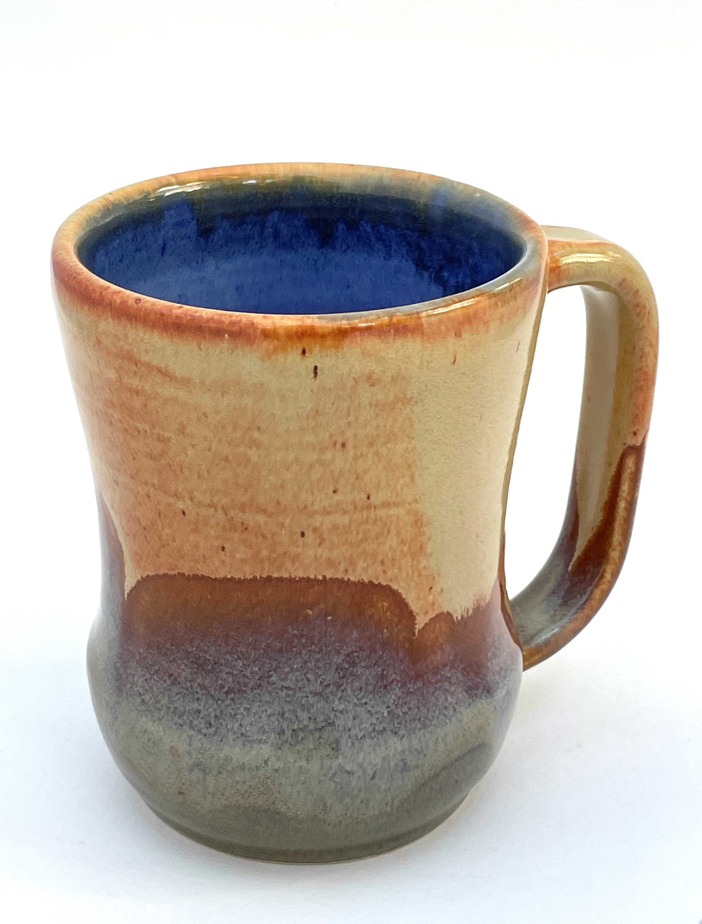 Ceramic mug with a blue interior, and orange, purple and green exterior